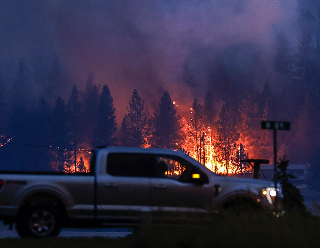 Flames from the Elmo Fire burn around Dayton, Mont., on the western shore of Flathead Lake