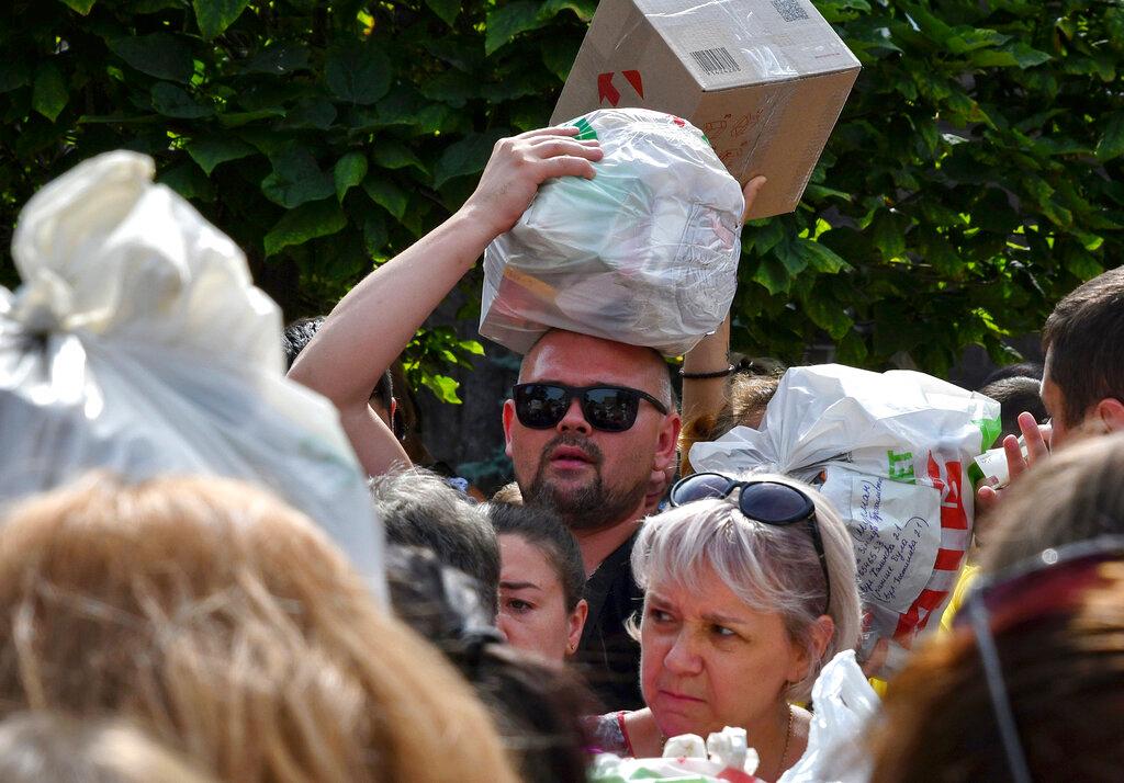 A group of people carrying received donations.