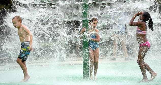 Children splash in the new splash pad at Riverview Park in North Augusta, S.C