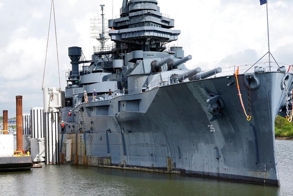 Preparations for moving the USS Texas continue Tuesday, Aug. 30, 2022, in La Porte, Texas. The vessel, which was commissioned in 1914 and served in both World War I and World War II, is scheduled to be towed down the Houston Ship Channel Wednesday to a dry dock in Galveston where it will undergo an extensive $35 million repair.