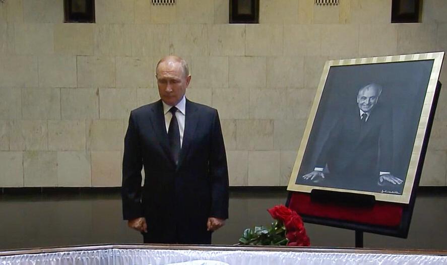 Russian President Vladimir Putin pays his last respect near the coffin of former Soviet President Mikhail Gorbachev 