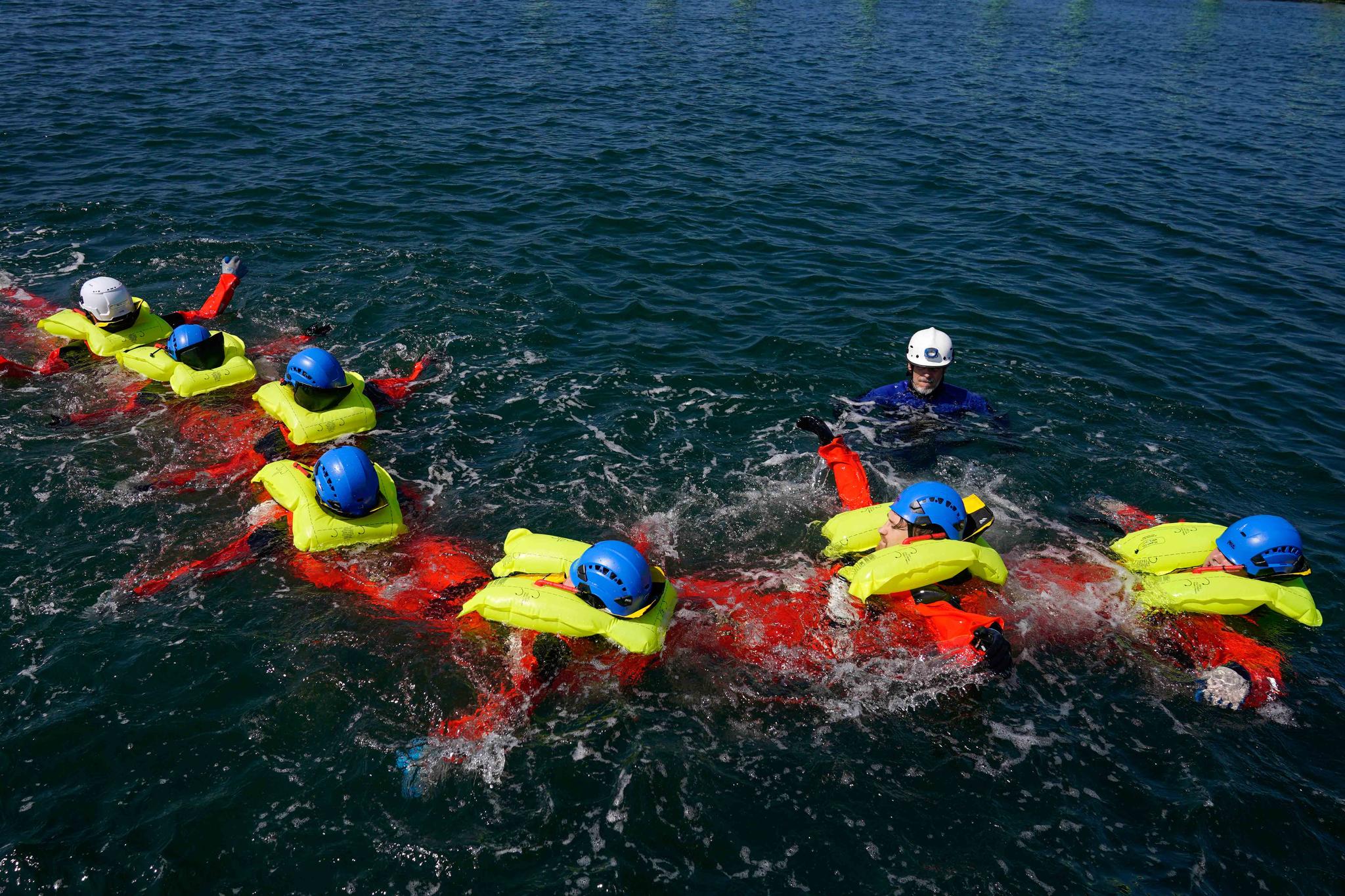 Participants in a Global Wind Organisation certification class learn how to do a group survival float at the Massachusetts Maritime Academy in Bourne, Mass., Thursday, Aug. 4, 2022.