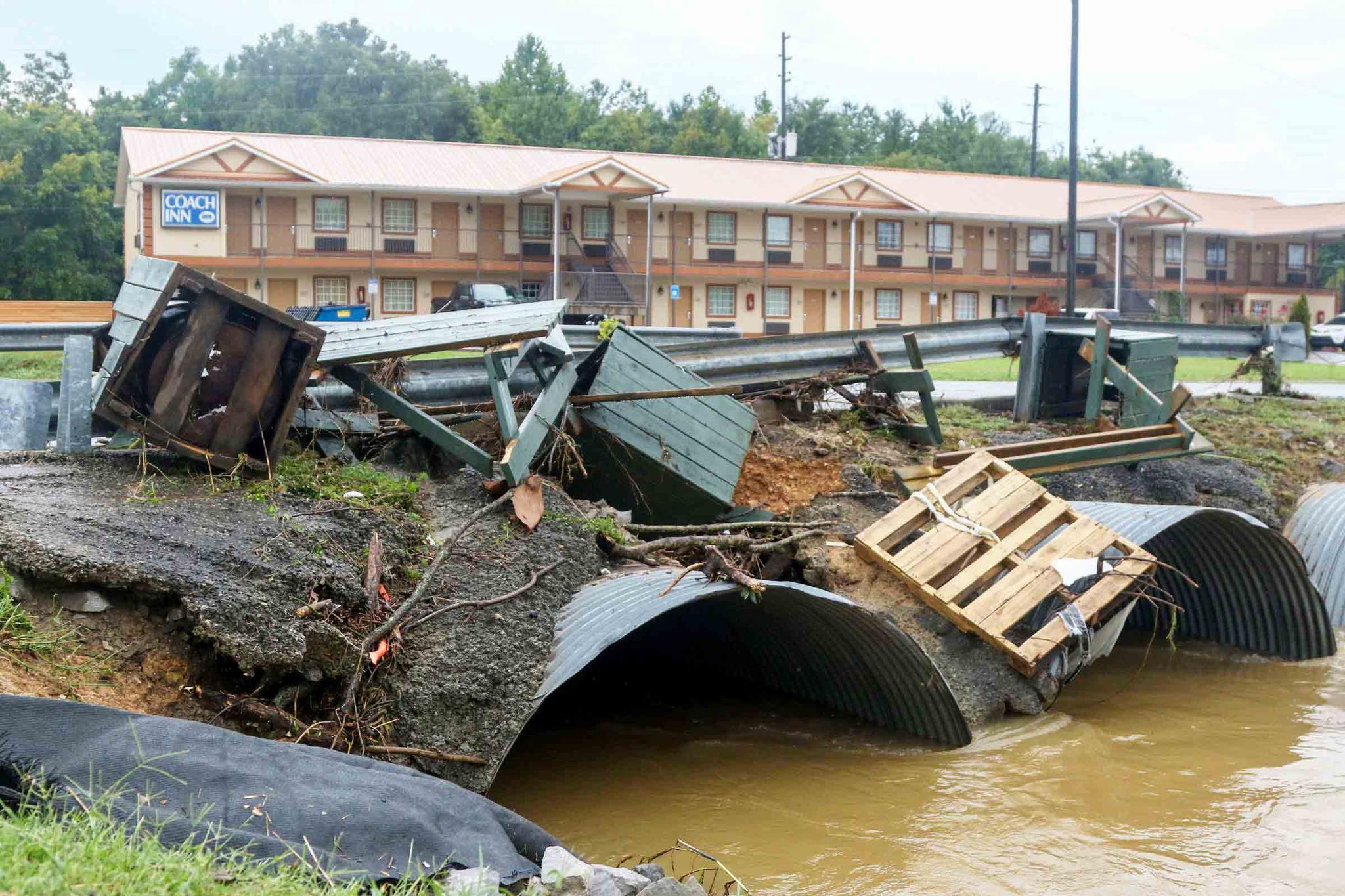 Trash cans from JR Dick Dowdy Park wash up outside of the Coach Inn Sunday, Sept. 4, 2022, in Summerville, Ga. 