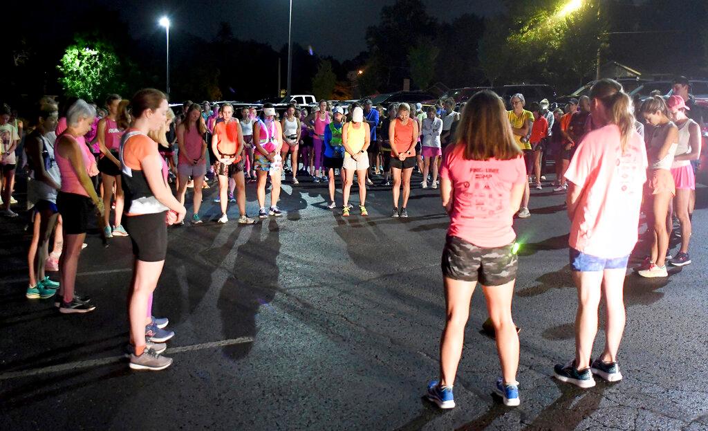 Runners pray before heading out for "Finish Eliza's Run" on Friday, Sept. 9, 2022 in Chattanooga, Tenn. The approximately four mile run was to memorialize, Eliza Fletcher