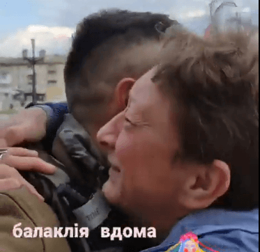 Grateful Ukrainian woman hugs soldier, cries