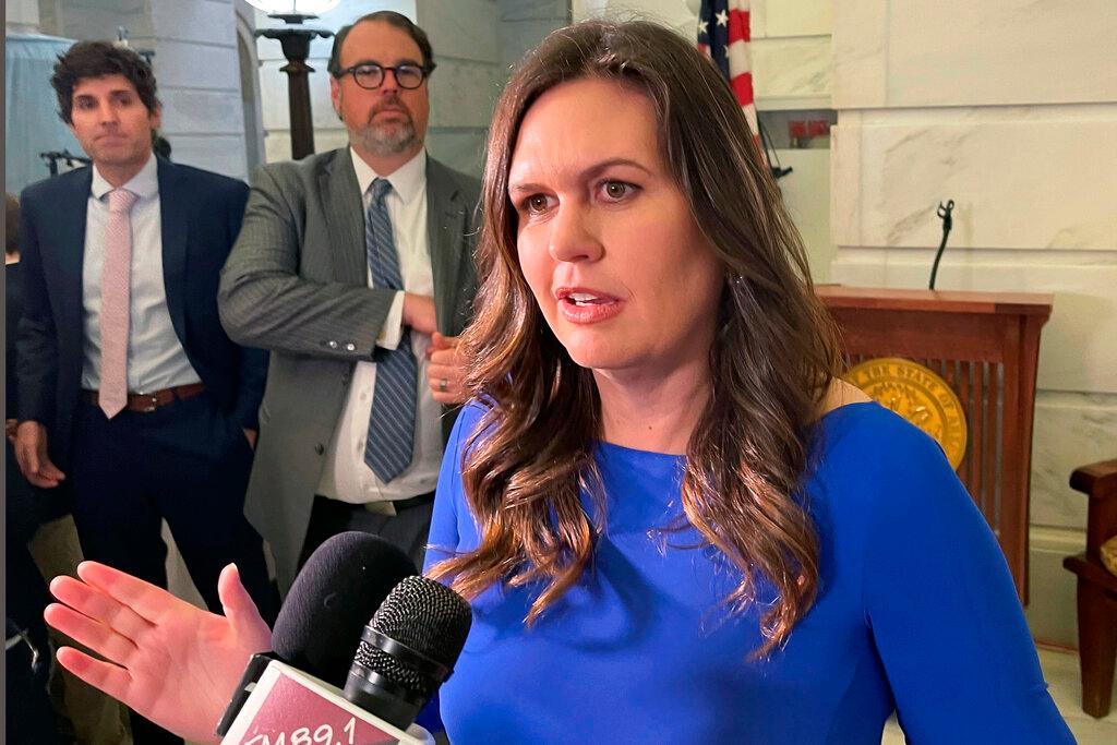 Sarah Sanders talks to reporters at the Arkansas state Capitol in Little Rock, Ark.