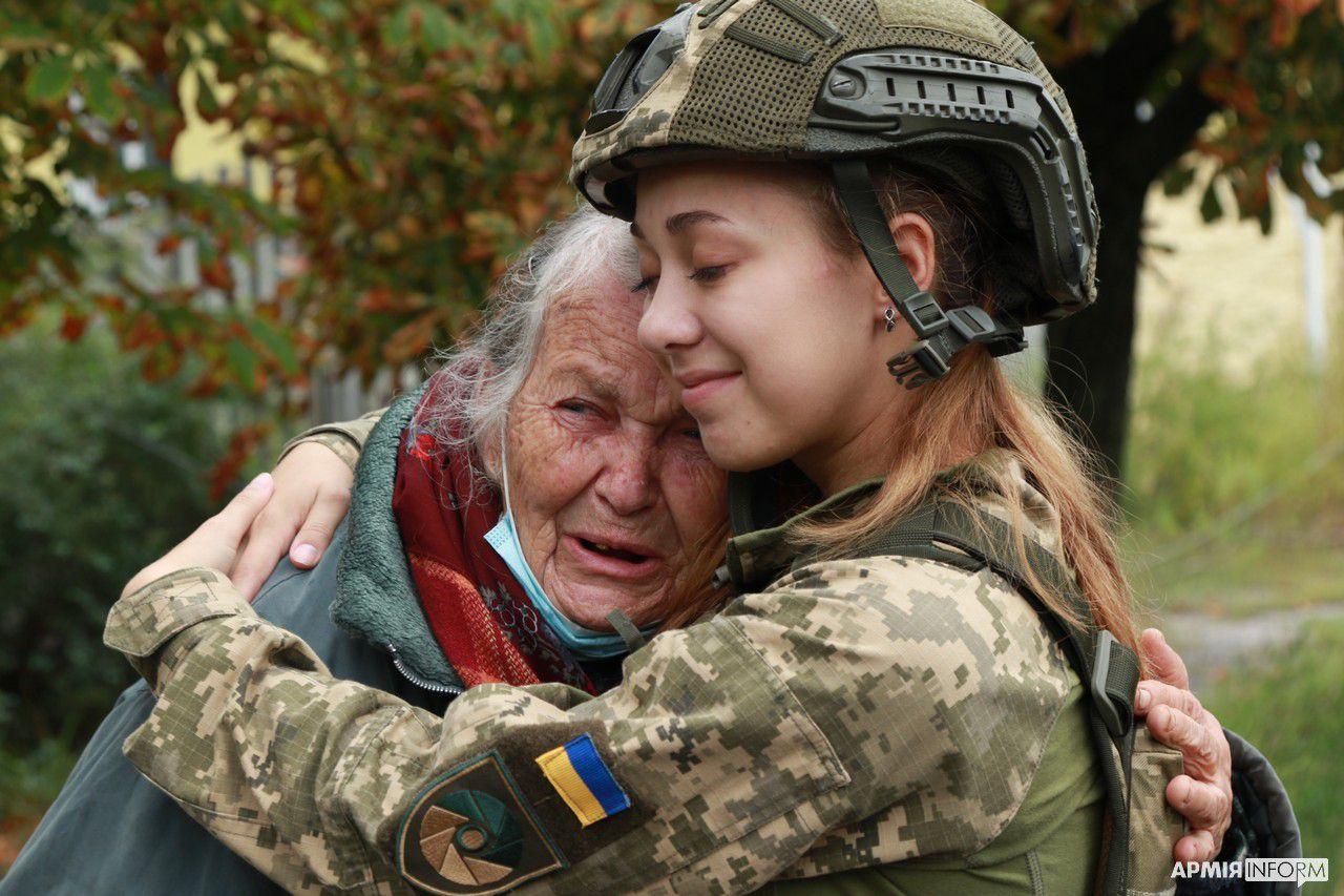 Ukrainian soldier comforts elderly resident