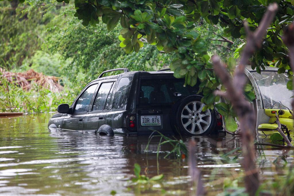 A vehicle is submerged after Hurricane Fiona in Salinas, Puerto Rico