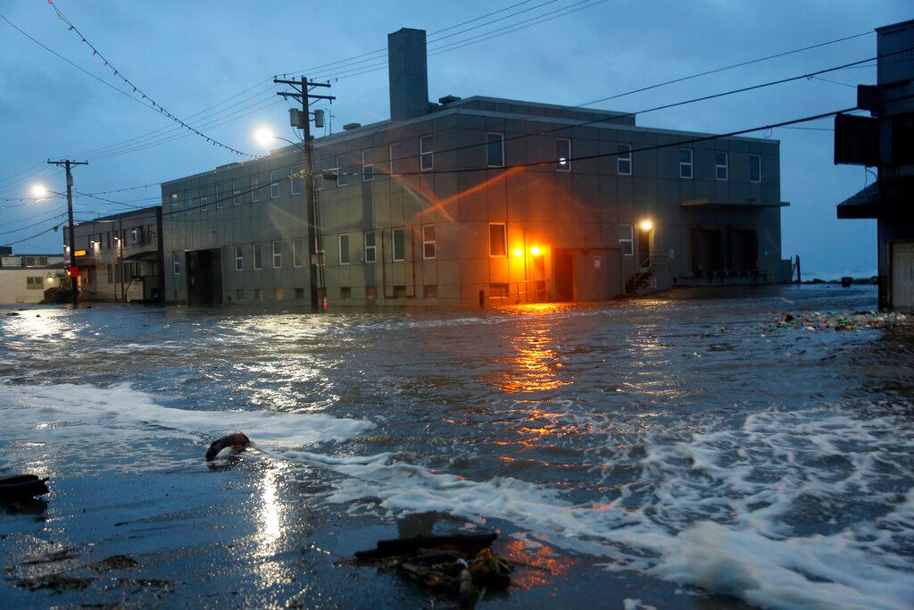 Water rushes down Front Street, just a half block from the Bering Sea, in Nome, Alaska