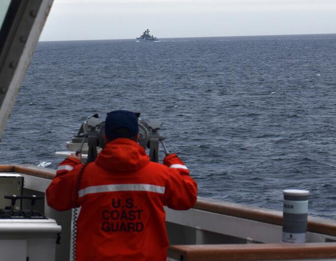 Coast Guard Cutter Kimball crew-member observes a foreign vessel in the Bering Sea