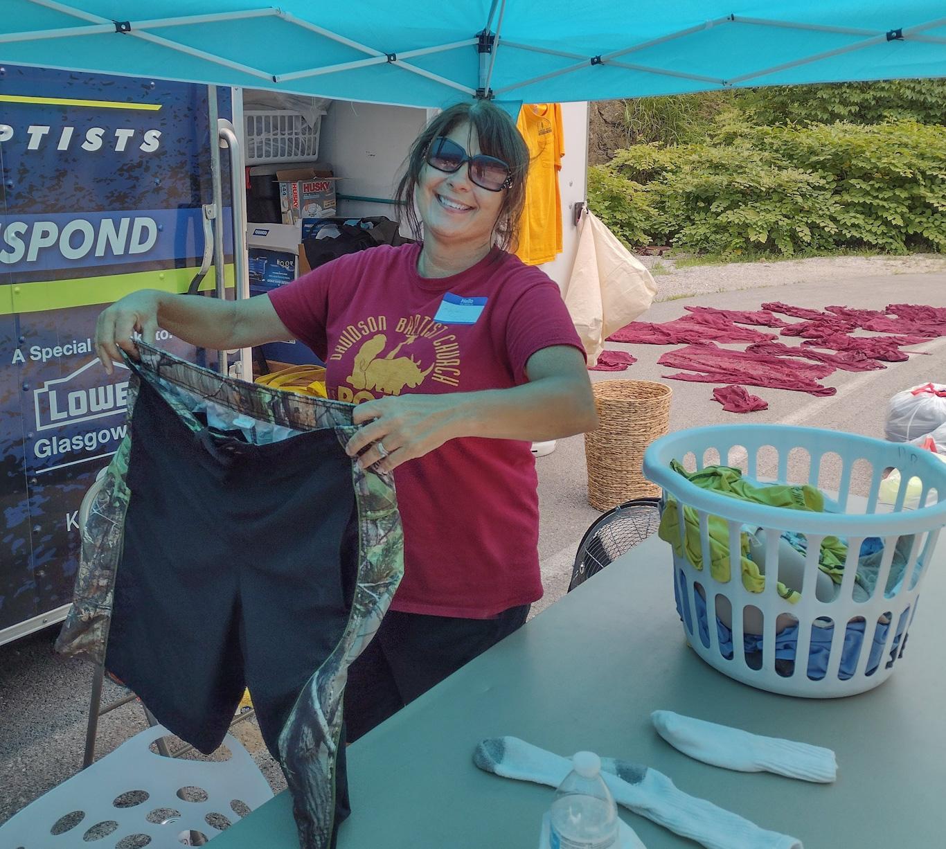 Volunteer laundry team washes 125 daily loads of flood-soaked clothing for survivors