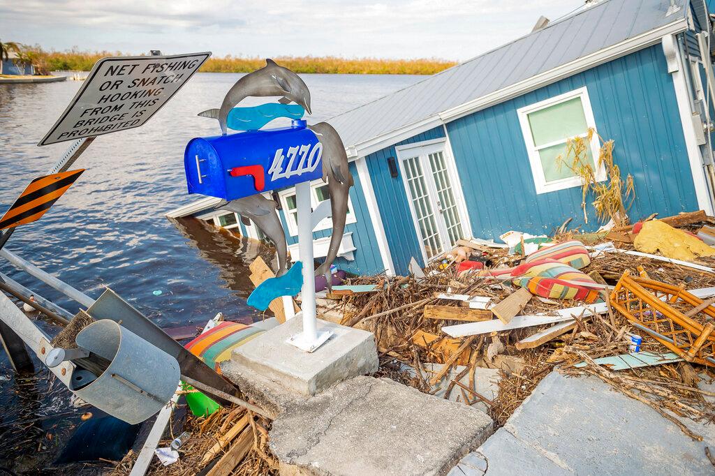 A residence sits partially submerged in water after Hurricane Ian leaves behind widespread damage across Pine Island, Fla.