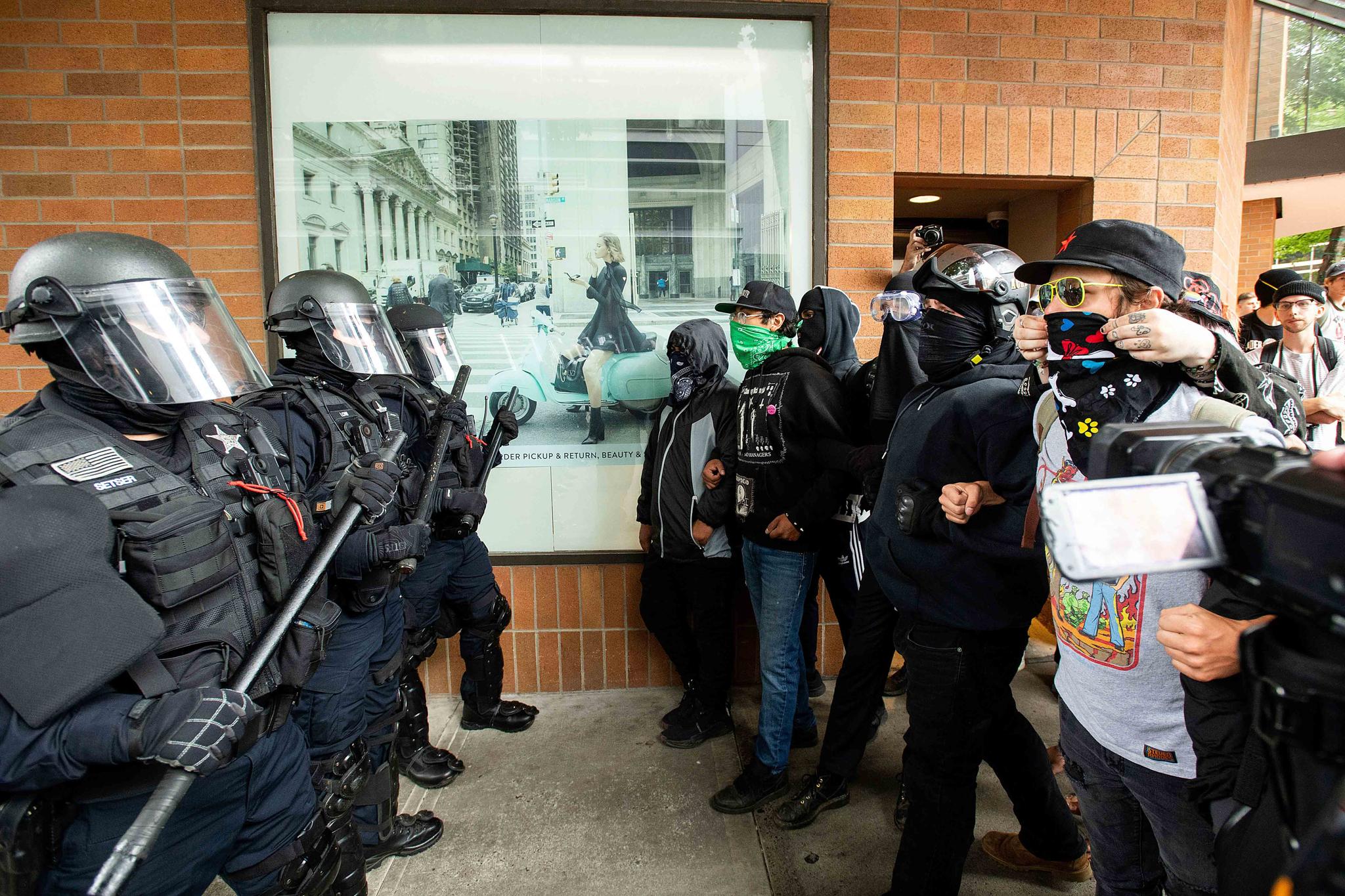 Police officers face off against ANTIFA members following an ultra-left rally in Portland