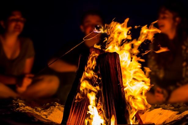 People sitting around bonfire