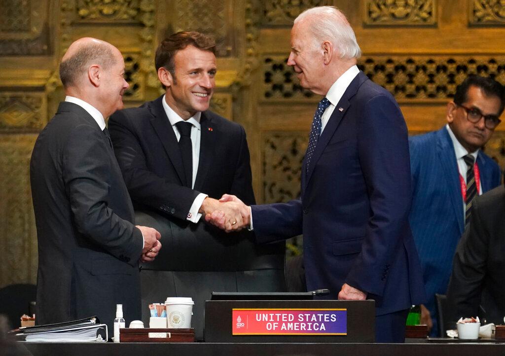 President Joe Biden, French President Emmanuel Macron and German Chancellor Olaf Scholz greet each other during the first working session of the G20 leaders' summit