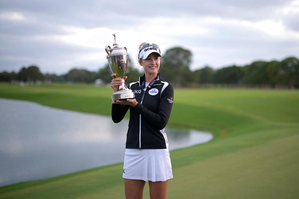 Nelly Korda holds the championship trophy after winning the LPGA Pelican Women's Championship golf tournament at Pelican Golf Club, Sunday, Nov. 13, 2022