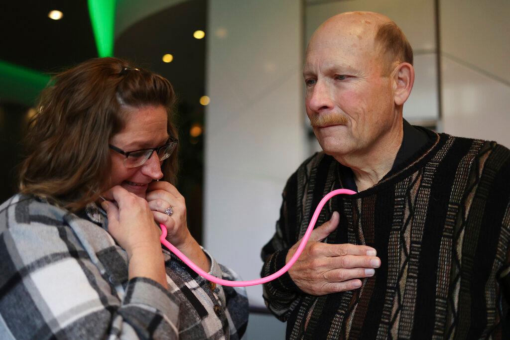 Amber Morgan, from South Bend, Ind., listens to the heartbeat of Tom Johnson, from Kankakee, Ill.