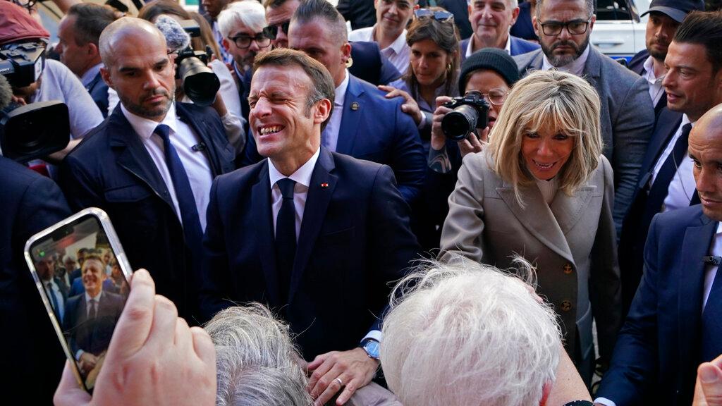 French President Emmanuel Macron and his wife Brigitte Macron greet the crowd as they arrive at Jackson Square in New Orleans