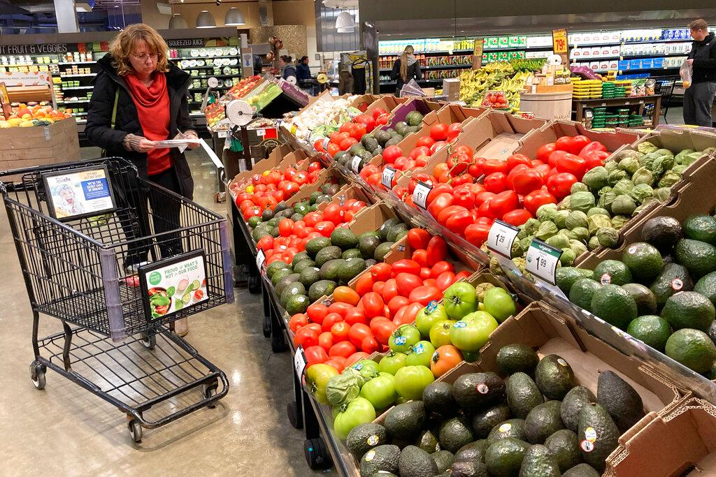 Shoppers pick out items at a grocery store in Glenview, Ill.