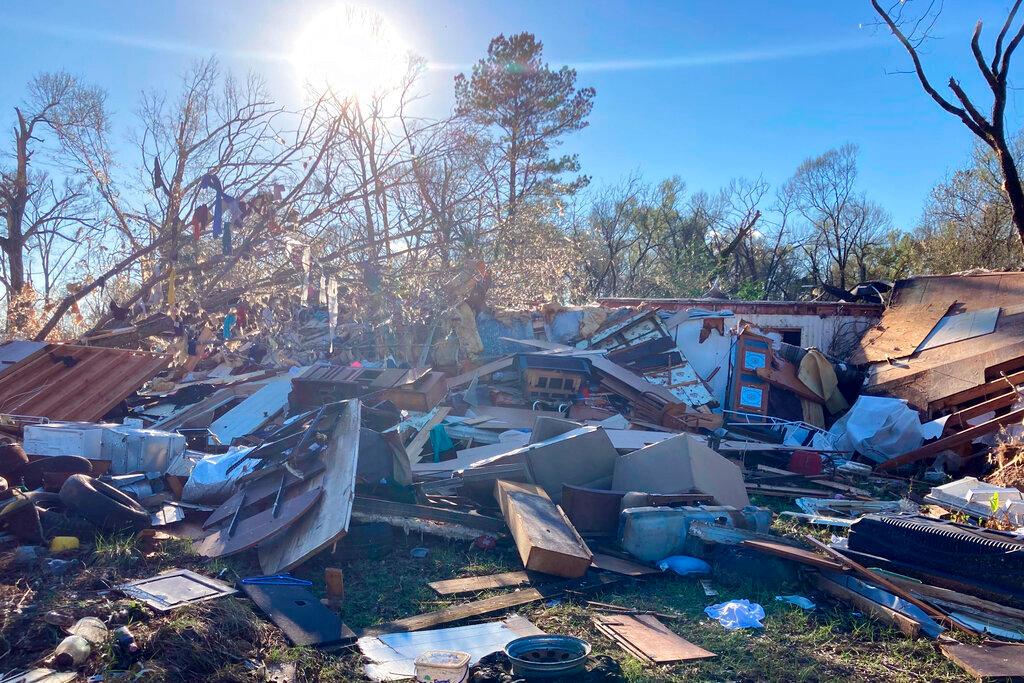 Debris is piled up following severe weather Wednesday, Dec. 14, 2022, in Keithville, La