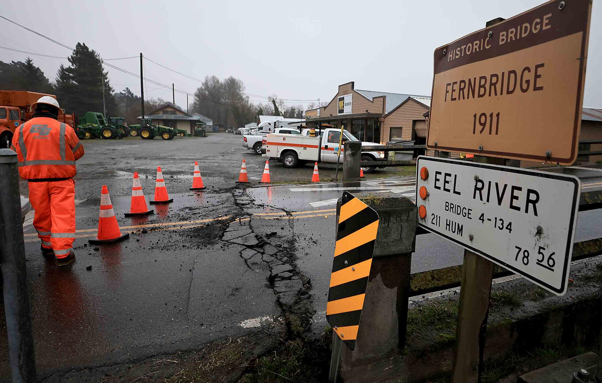 Caltrans workers inspect Fernbridge, the main arterial that connects Ferndale over the Eel River, after an earthquake near Fortuna, Calif., Tuesday, Dec. 20, 2022.