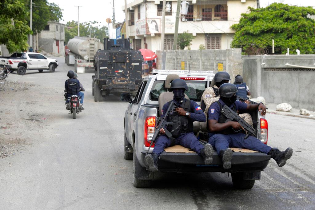 A police convoy escort fuel trucks filled with gas as they drive from the Varreux fuel terminal, in Port-au-Prince, Haiti