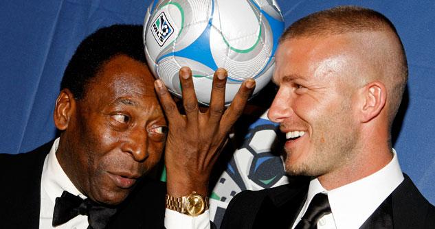 Pele holding up a soccer ball next to a smiling David Beckham