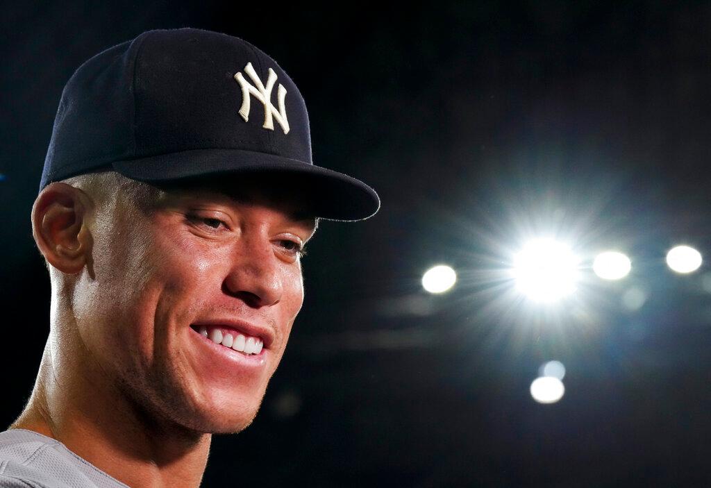 New York Yankees' Aaron Judge smiles as he speaks during an interview after the team's baseball game against the Toronto Blue Jays, in which he hit his 61st home run of the season.