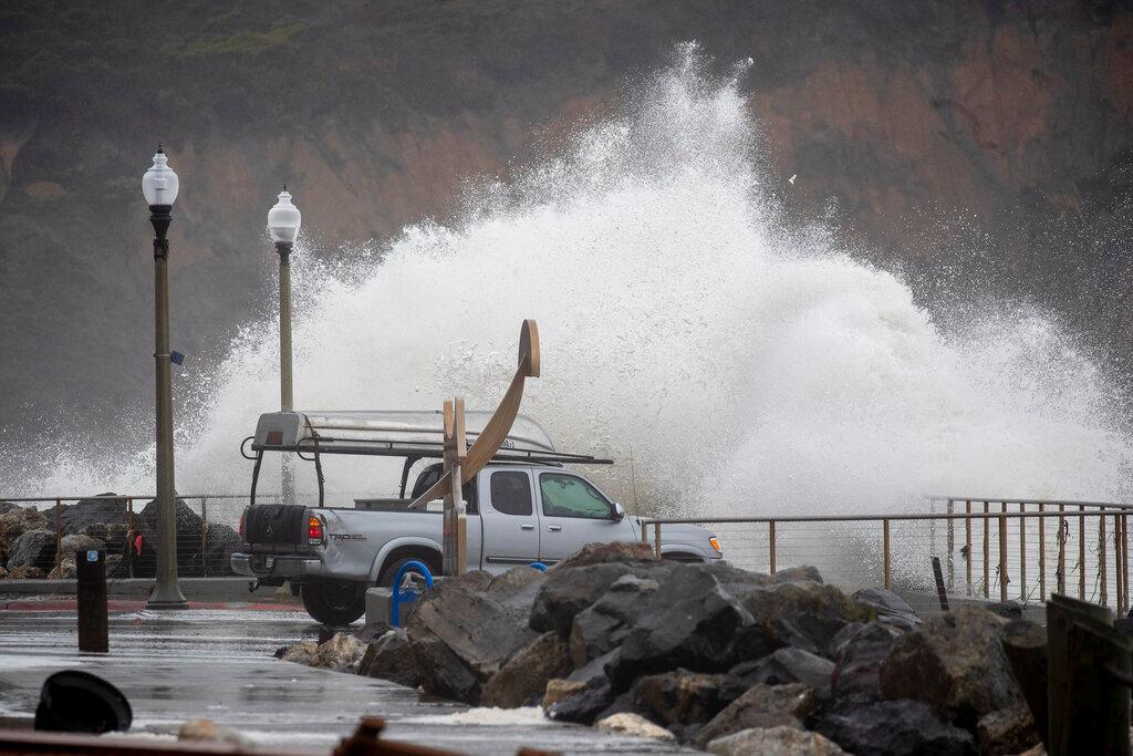 Breakers crash behind motorists viewing the ocean at Rockaway Beach in Pacifica, Calif.