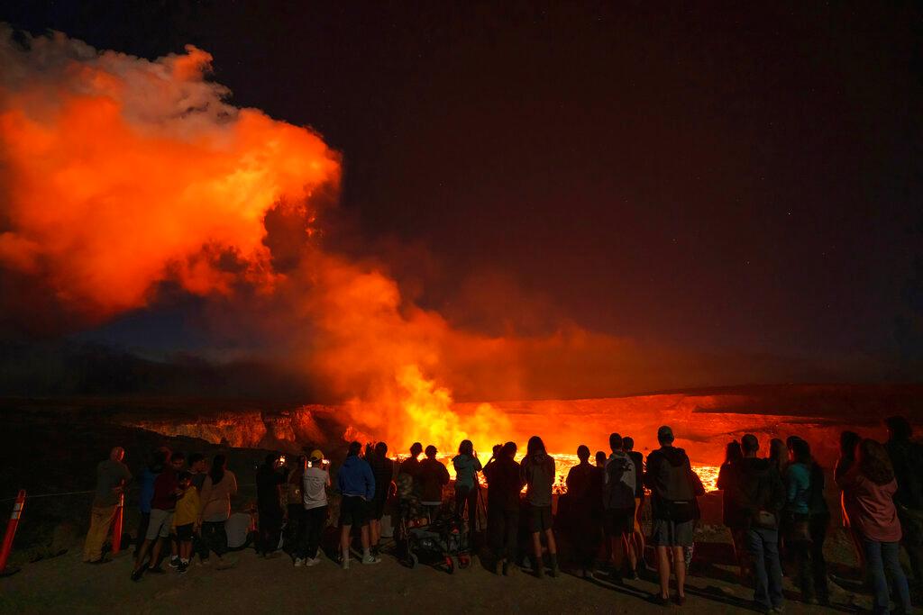 People watching the eruption inside the summit crater of the Kilauea volcano on the Big Island of Hawaii, Thursday, Jan. 5, 2023. 