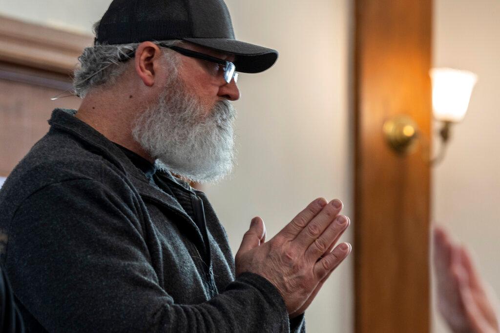 Boris Levins holds his hands in prayer while worshiping with Blue Jean Church. 