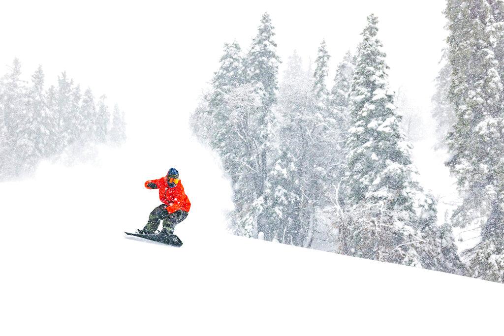 Snowboarder slides after one of the most significant storms of the season in Big Bear Mountain Ski resort, with 17" of snow over the last two days in Big Bear Lake, Calif.