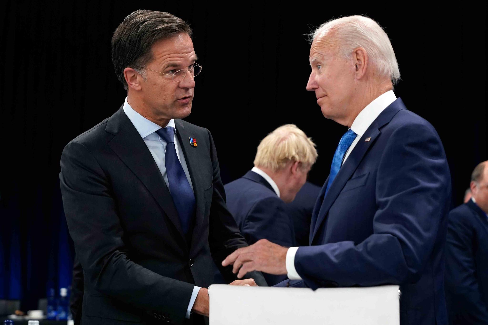 Netherland's Prime Minister Mark Rutte, left, speaks with U.S. President Joe Biden during a round table meeting at a NATO summit in Madrid, Spain, June 29, 2022.