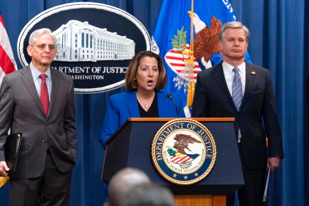 Deputy Attorney General Lisa Monaco flanked by Attorney General Merrick Garland, left, and Federal Bureau of Investigation (FBI) Director Christopher Wray 