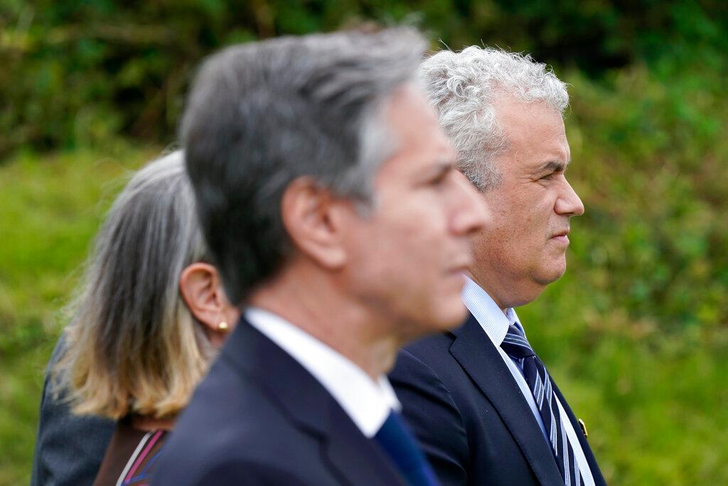 Secretary of State Antony Blinken, front, and Jeff Zients, White House coronavirus response coordinator, right, listen as President Joe Biden speaks about his administration's global COVID-19 vaccination efforts ahead of the G-7 summit, Thursday, June 10, 2021, in St. Ives, England. 