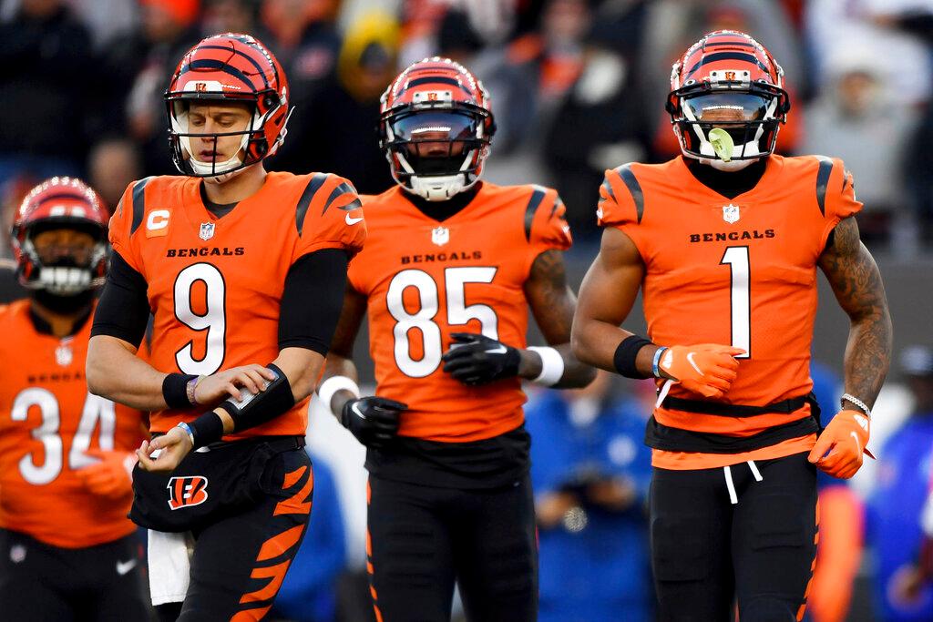  Cincinnati Bengals quarterback Joe Burrow (9), wide receiver Tee Higgins (85) and Cincinnati Bengals wide receiver Ja'Marr Chase (1) run onto the field during an NFL football game against the Kansas City Chiefs.