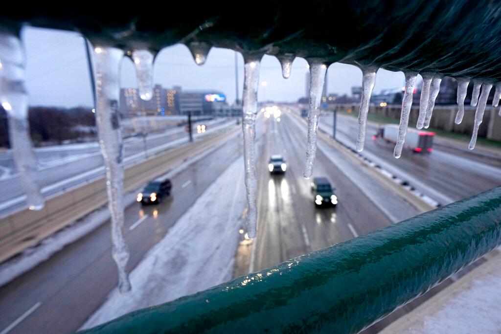 Icicles form on a rail on an overhead pass railing as drivers make their way north on US 75, Wednesday, Feb. 1, 2023, in Dallas. 