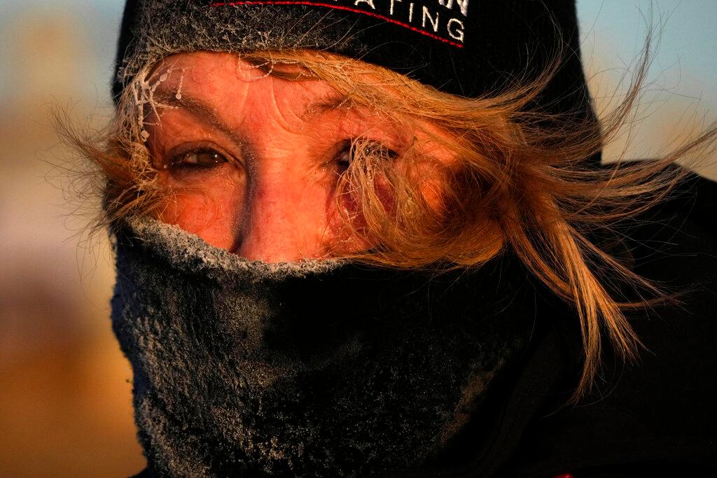 Frost clings to the hair of Joyce Love as she looks at arctic sea smoke on the coast of South Portland, Maine, Saturday, Feb. 4, 2023. The morning temperature was about -10 degrees Fahrenheit. 