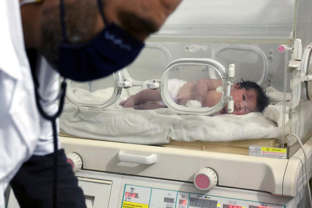 A baby girl who was born under the rubble caused by an earthquake that hit Syria and Turkey receives treatment inside an incubator at a children's hospital in the town of Afrin, Aleppo province, Syria. Her mother did not survive.