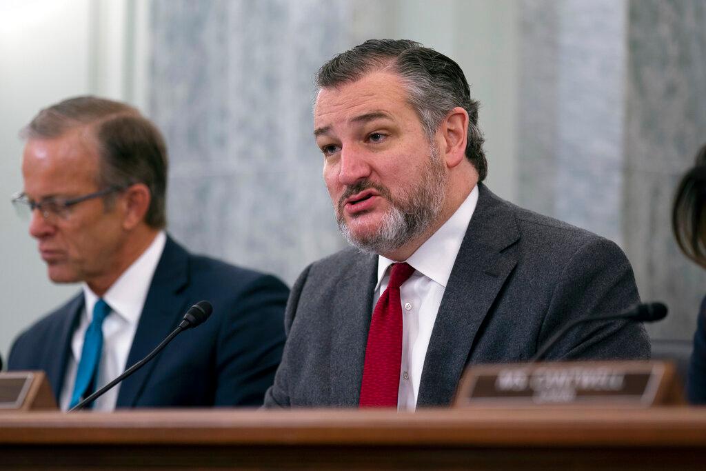 Sen. Ted Cruz, R-Texas, center, the ranking member of the Senate Commerce, Science, and Transportation Committee, is flanked by Sen. John Thune, R-S.D., left, and by Chair Maria Cantwell, D-Wash.