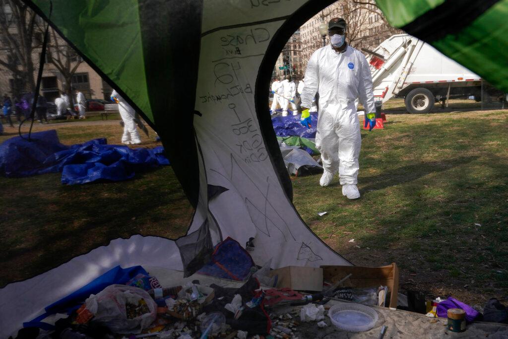 Workers clear a homeless encampment at McPherson Square in Washington