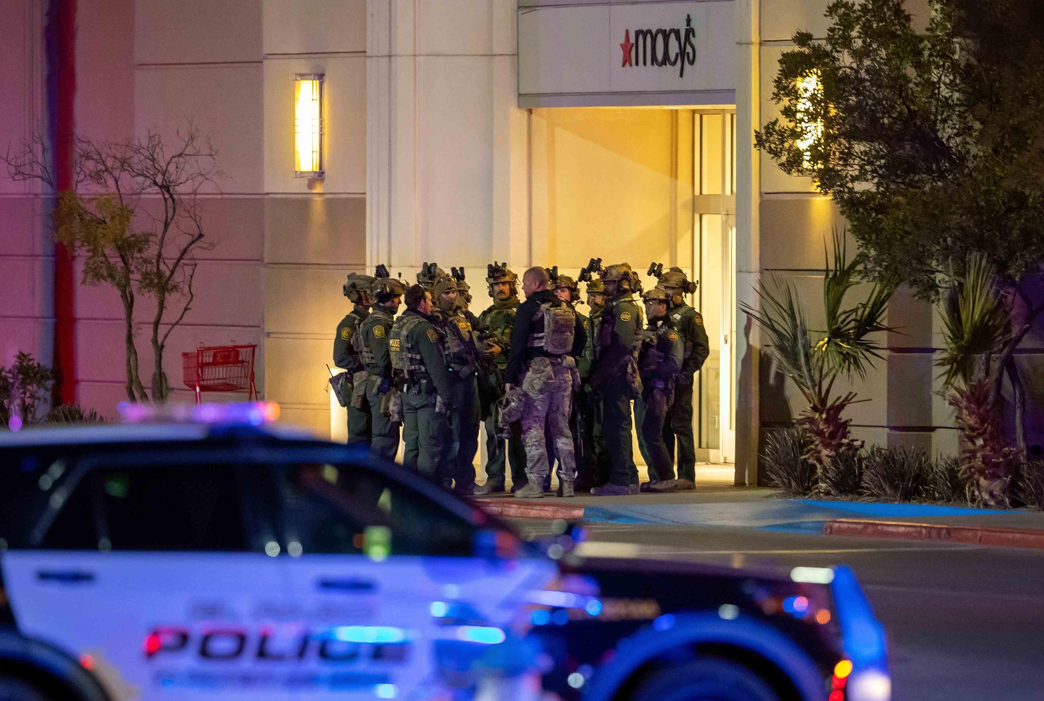 Police officers gather at an entrance of a shopping mall, Wednesday, Feb. 15, 2023, in El Paso, Texas.