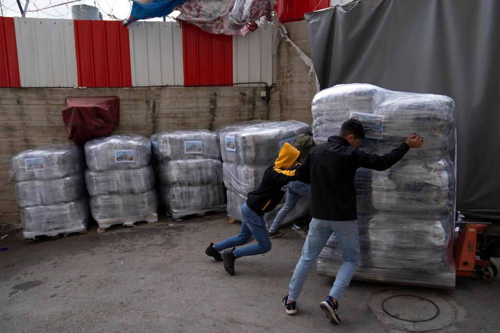 Workers prepare a shipment of sleeping gear for homeless victims of the earthquake in Turkey and Syria now exposed to the freezing winter weather, at a Palestinian factory in the West Bank city of Hebron, Thursday, Feb. 16, 2023. Palestinians have pitched in to help those reeling from the devastating earthquake in Turkey and Syria, with the Palestinian Authority even sending a team of medics and other experts to support Turkish and Syrian rescue efforts.