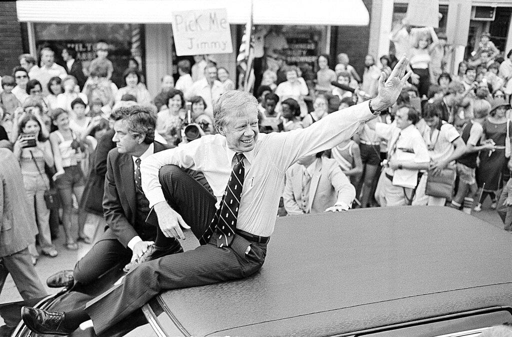 President Jimmy Carter waves from the roof of his car along the parade route through Bardstown, Ky., July 31, 1979.