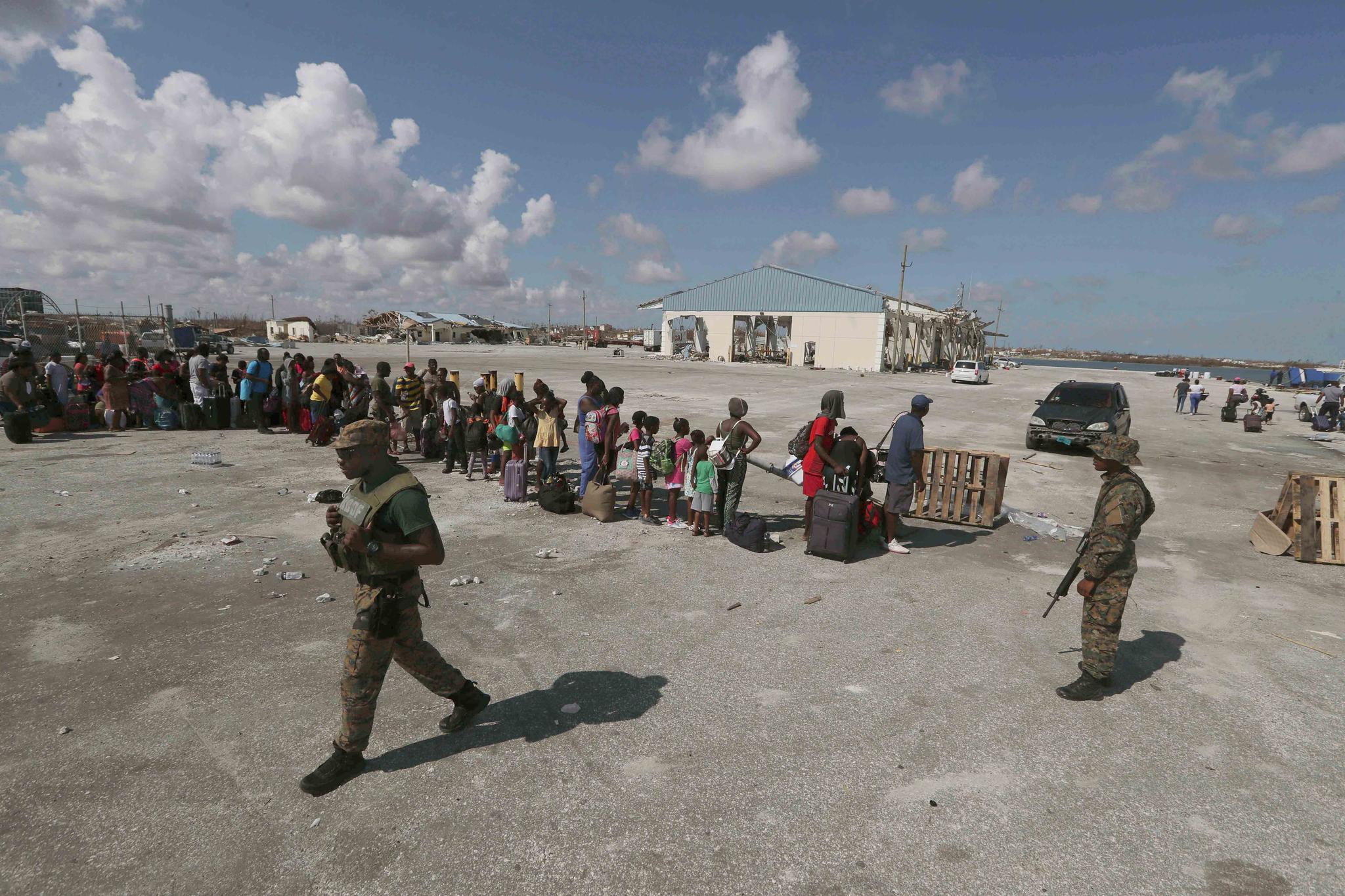 People line up prior boarding a ferry to Nassau at the Port in Marsh Harbor