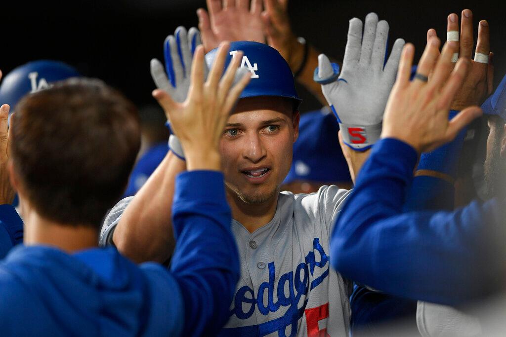 Los Angeles Dodgers' Corey Seager is congratulated in the dugout for his three-run home run during the first inning of the team's baseball game against the Baltimore Orioles, Tuesday, Sept. 10, 2019, in Baltimore.