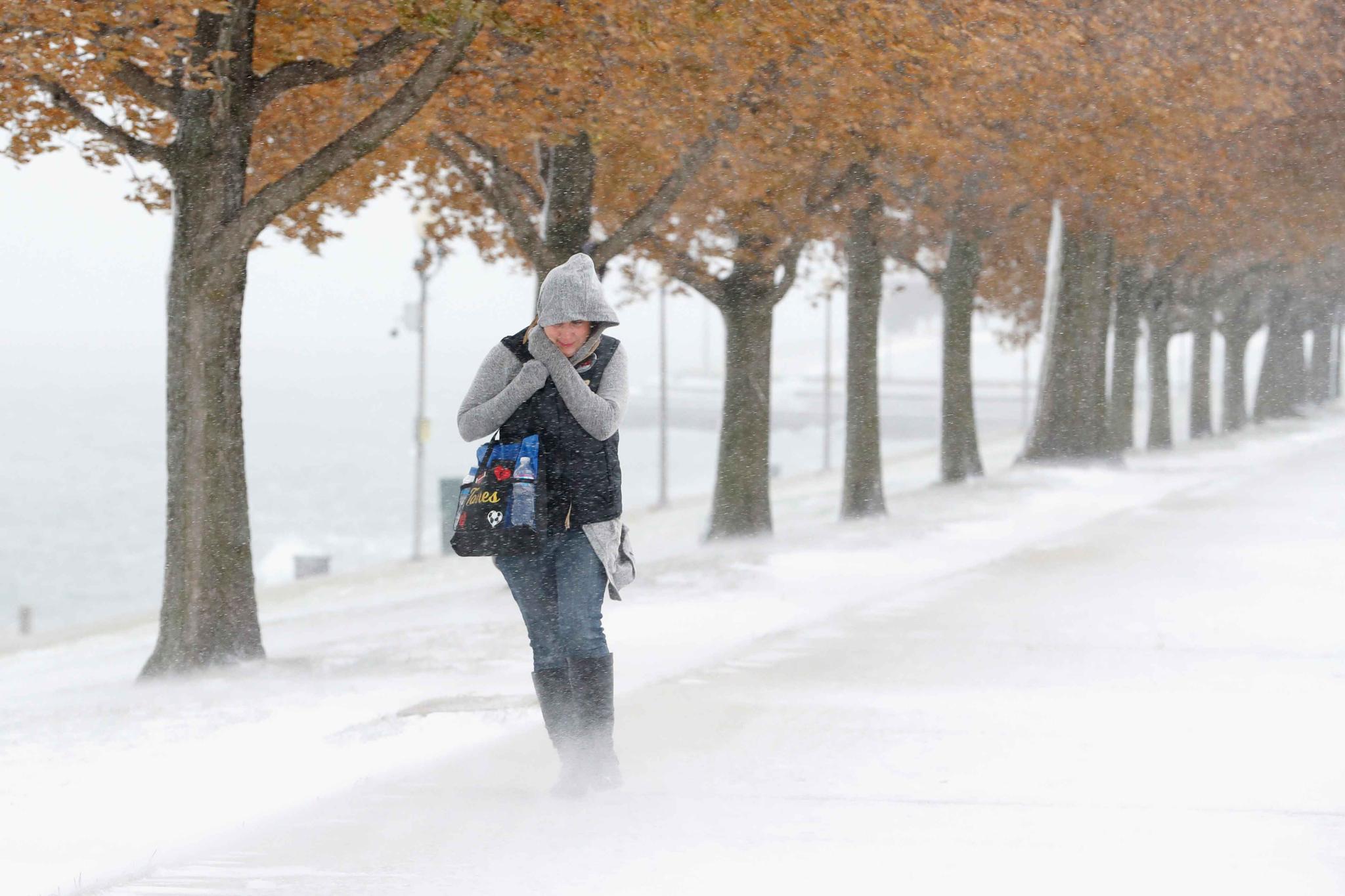 Woman walking in snow and wind in Chicago