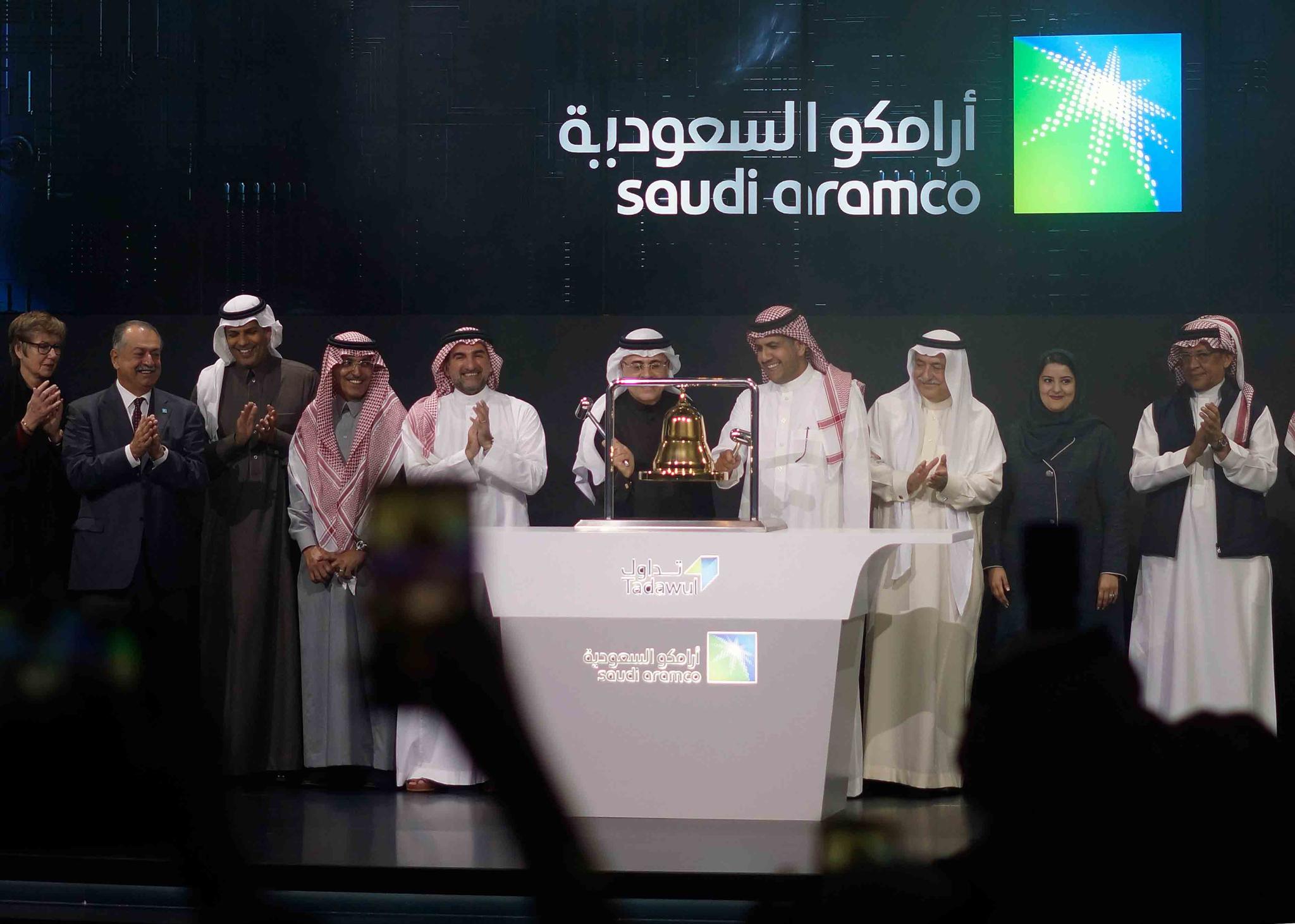 Saudi Arabia's state-owned oil company Saudi Armco and stock market officials celebrate during the official ceremony marking the debut of Aramco's initial public offering (IPO)