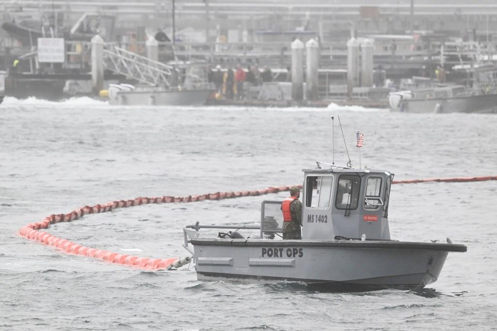 Boat with a large net or series of bouys in the bay