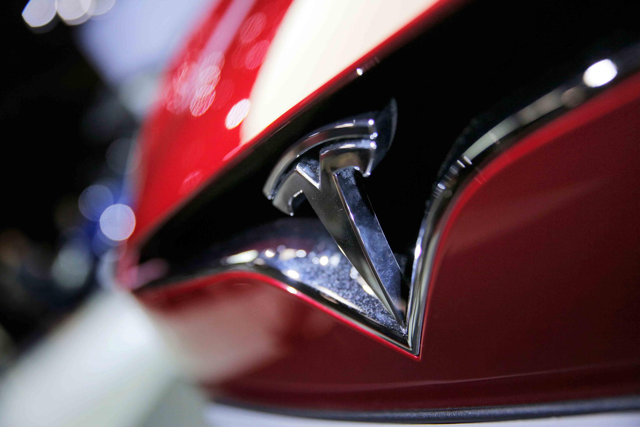 file photo shows the logo of the Tesla model S at the Paris Auto Show in Paris, France